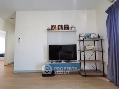 Modern living room with TV, shelf, and stylish decor