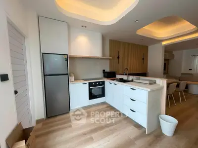 Modern open-layout kitchen with sleek appliances and stylish lighting