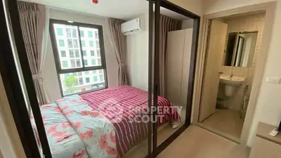 Cozy bedroom with large window and ensuite bathroom in modern apartment