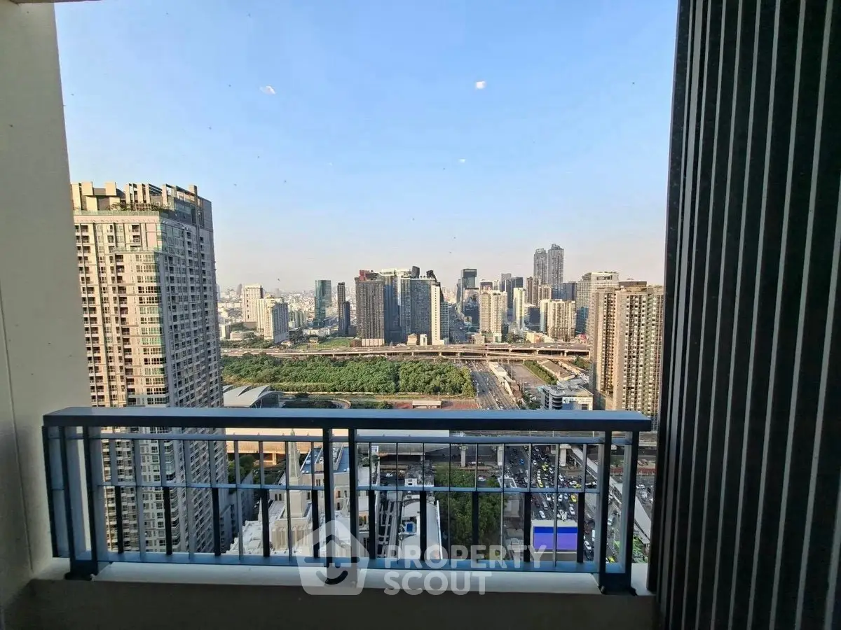 Stunning cityscape view from a high-rise balcony overlooking urban skyline.