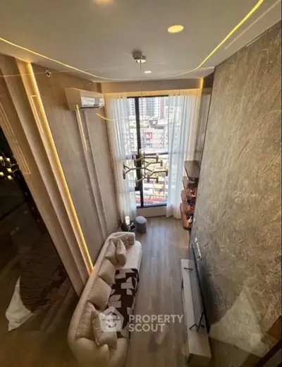 Luxurious high-ceiling living room with modern decor and large windows offering city views.