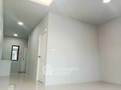 Spacious modern interior with sleek white walls and bright lighting, perfect for customization.