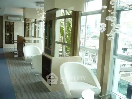 Luxurious modern living area with panoramic city views and elegant seating.