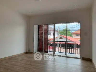 Spacious empty room with large windows and balcony view in modern home