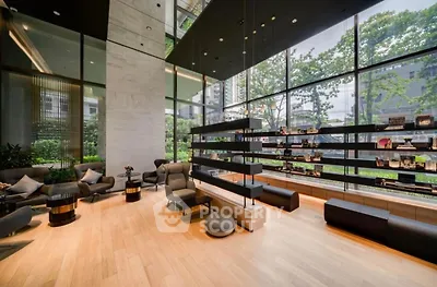 Luxurious modern living room with floor-to-ceiling windows and elegant furnishings.