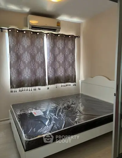 Cozy bedroom with air conditioning and elegant curtains, perfect for restful nights.
