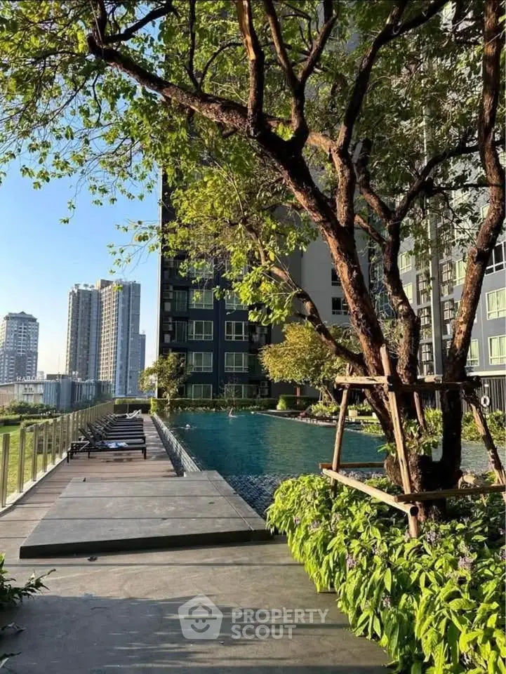 Luxurious high-rise building with stunning pool and lush greenery, perfect for urban living.