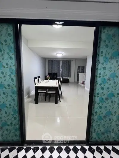 Spacious dining area with elegant table and chairs, perfect for family gatherings in a modern home.