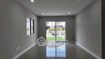 Spacious unfurnished room with large windows and sliding glass door