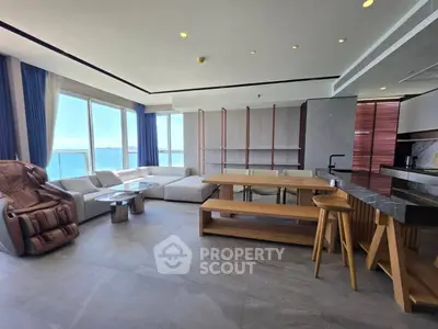 Luxurious open-plan living room with stunning ocean view and modern furnishings