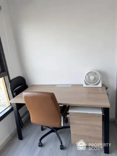 Modern study room with sleek desk and comfortable chair, ideal for productivity and focus.