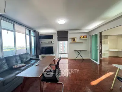 Spacious living room with modern furniture and large windows offering natural light.