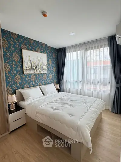 Elegant bedroom with stylish wallpaper and large window for natural light