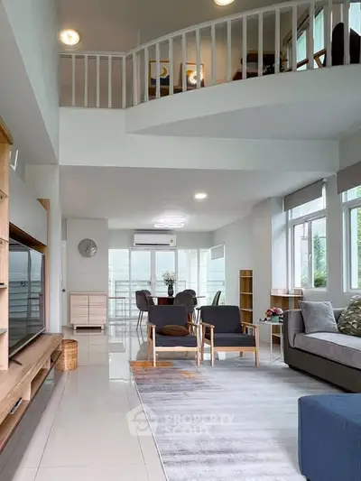 Spacious modern living room with high ceiling and stylish furniture