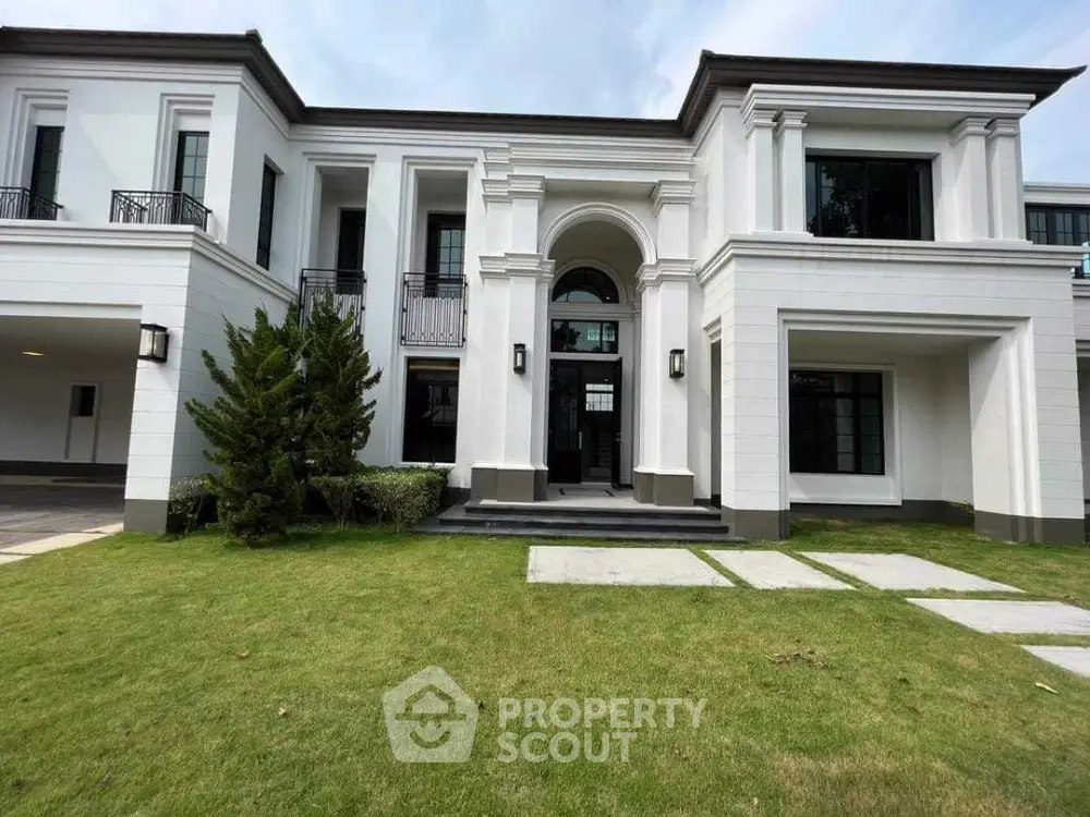 Luxurious modern mansion with elegant facade and lush green lawn