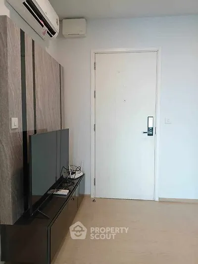 Modern living room with sleek TV setup and air conditioning