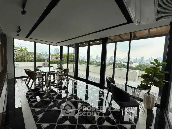 Luxurious penthouse with stunning city skyline view and elegant interior design.