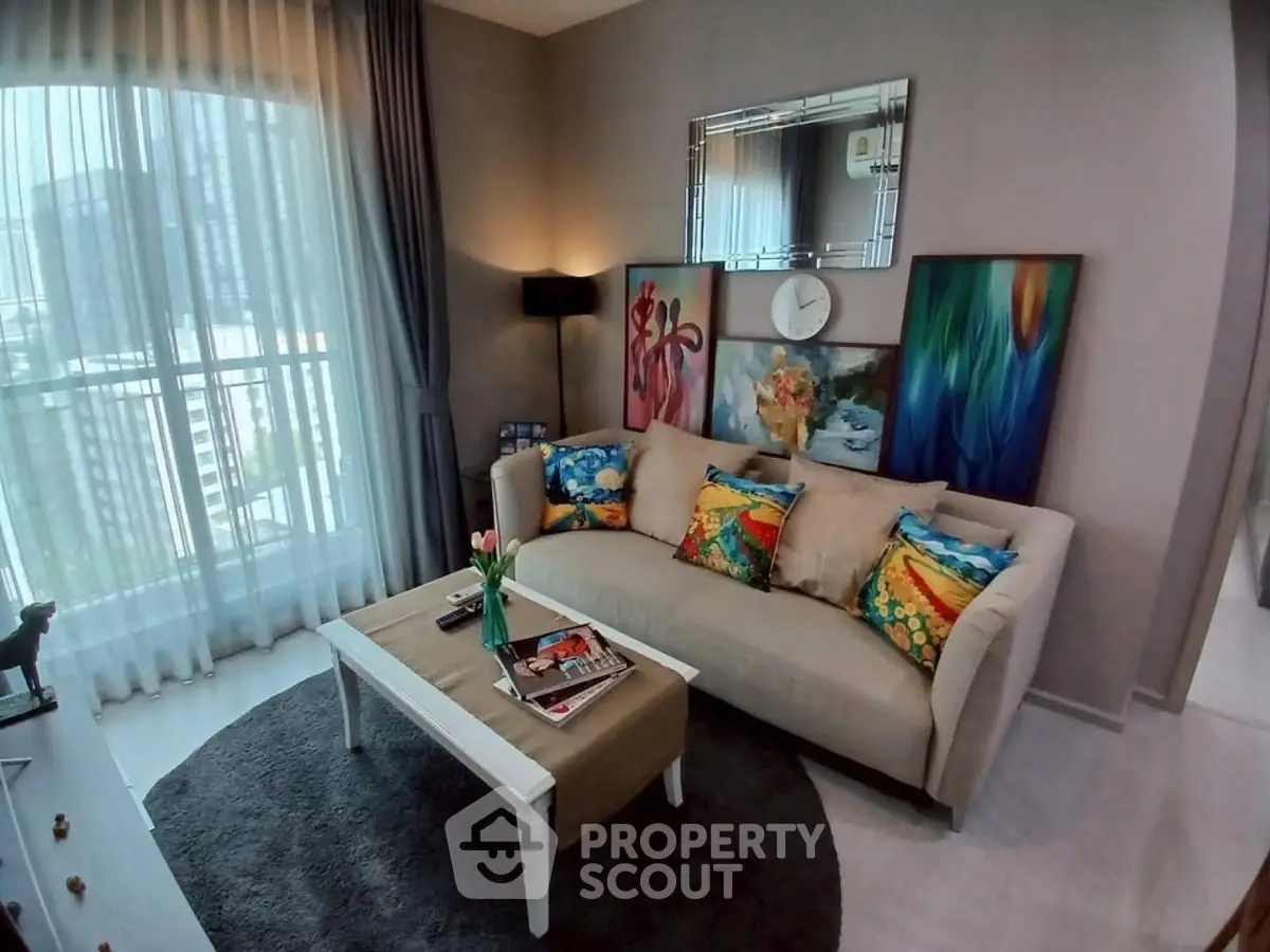 Stylish living room with modern decor and vibrant artwork in a high-rise apartment.