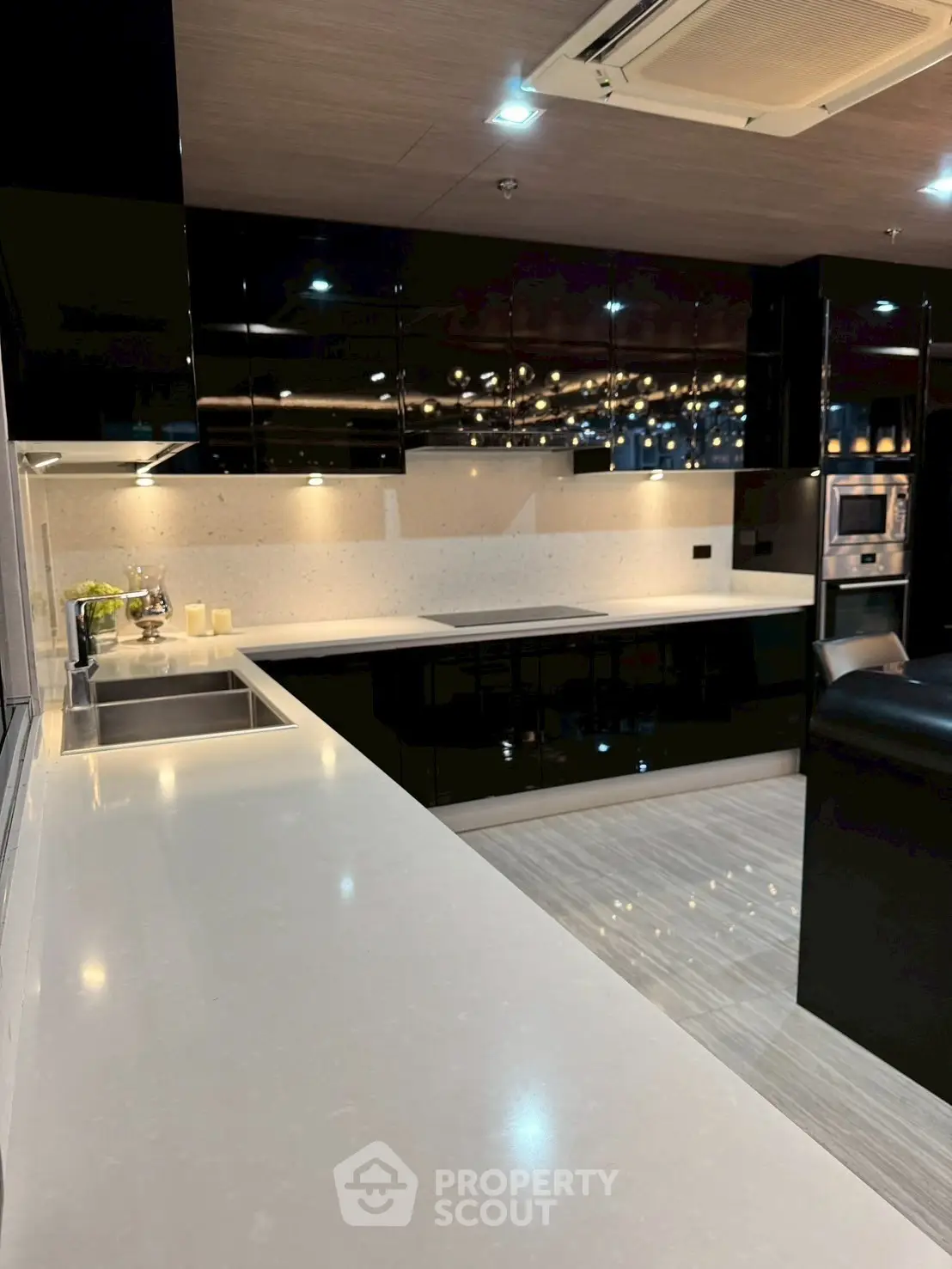 Luxurious modern kitchen with sleek black cabinets and spacious countertops