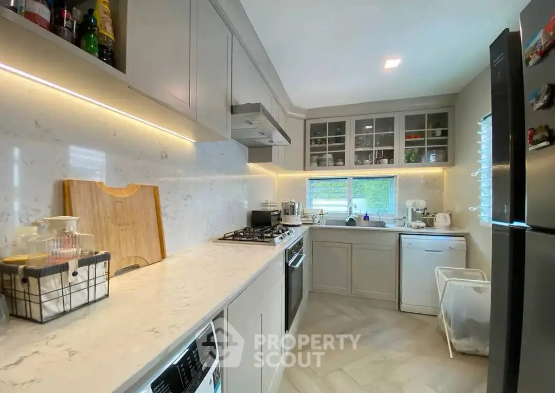 Modern kitchen with sleek cabinetry, gas stove, and ample counter space, perfect for culinary enthusiasts.