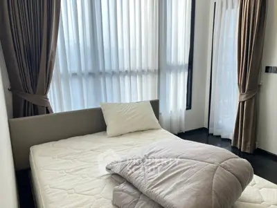 Cozy bedroom with large windows and elegant curtains, perfect for natural light lovers.