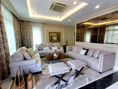 Luxurious living room with elegant sofas, stylish decor, and ambient lighting for a sophisticated ambiance.