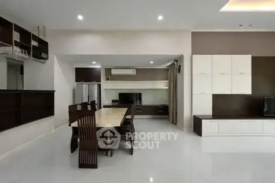 Spacious modern living room with dining area and sleek furniture, perfect for family gatherings.