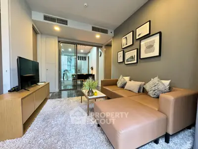 Modern living room with stylish decor and cozy seating in a contemporary apartment.