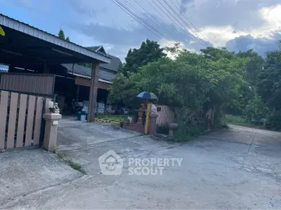 Charming suburban home with lush greenery and spacious driveway