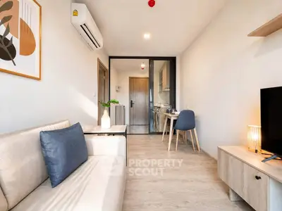 Modern living room with stylish decor and open kitchen layout in a cozy apartment.