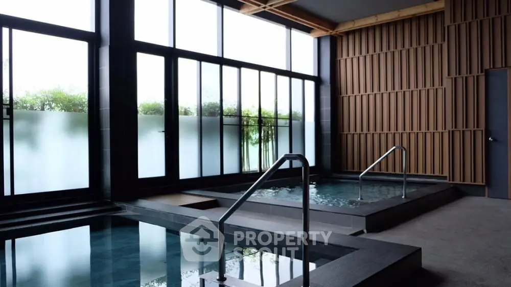 Luxurious indoor pool area with modern design and large windows