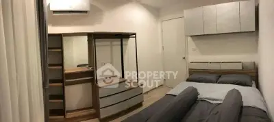 Cozy bedroom with modern furniture and air conditioning in a stylish apartment.
