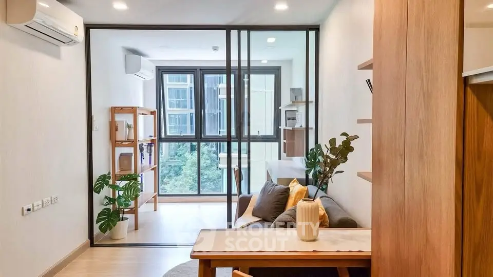 Modern living room with large windows and stylish decor in a contemporary apartment.