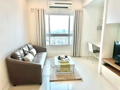 Modern living room with city view, featuring a cozy sofa, sleek TV setup, and a stylish workspace.
