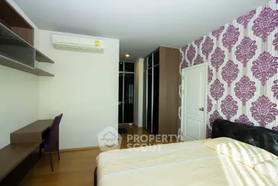 Stylish bedroom with modern decor and elegant wallpaper, featuring a cozy bed and built-in storage.