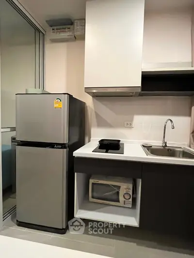 Modern kitchen with sleek appliances and compact design