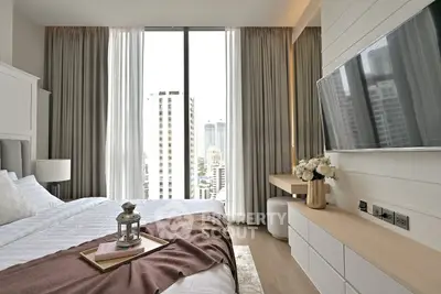 Luxurious bedroom with city view, modern decor, and large windows for natural light.