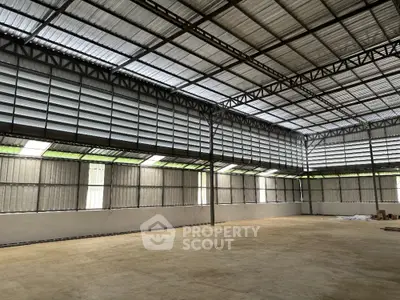 Spacious industrial warehouse with high ceilings and ample natural light