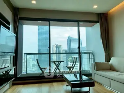 Modern living room with stunning city view and large balcony.