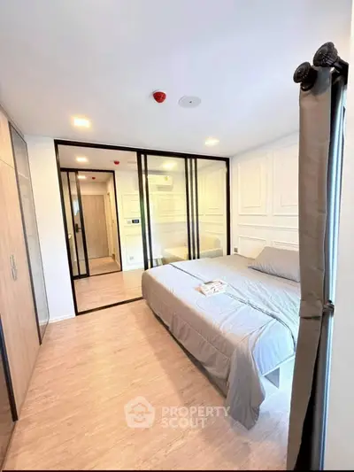 Modern bedroom with mirrored closet doors and elegant decor