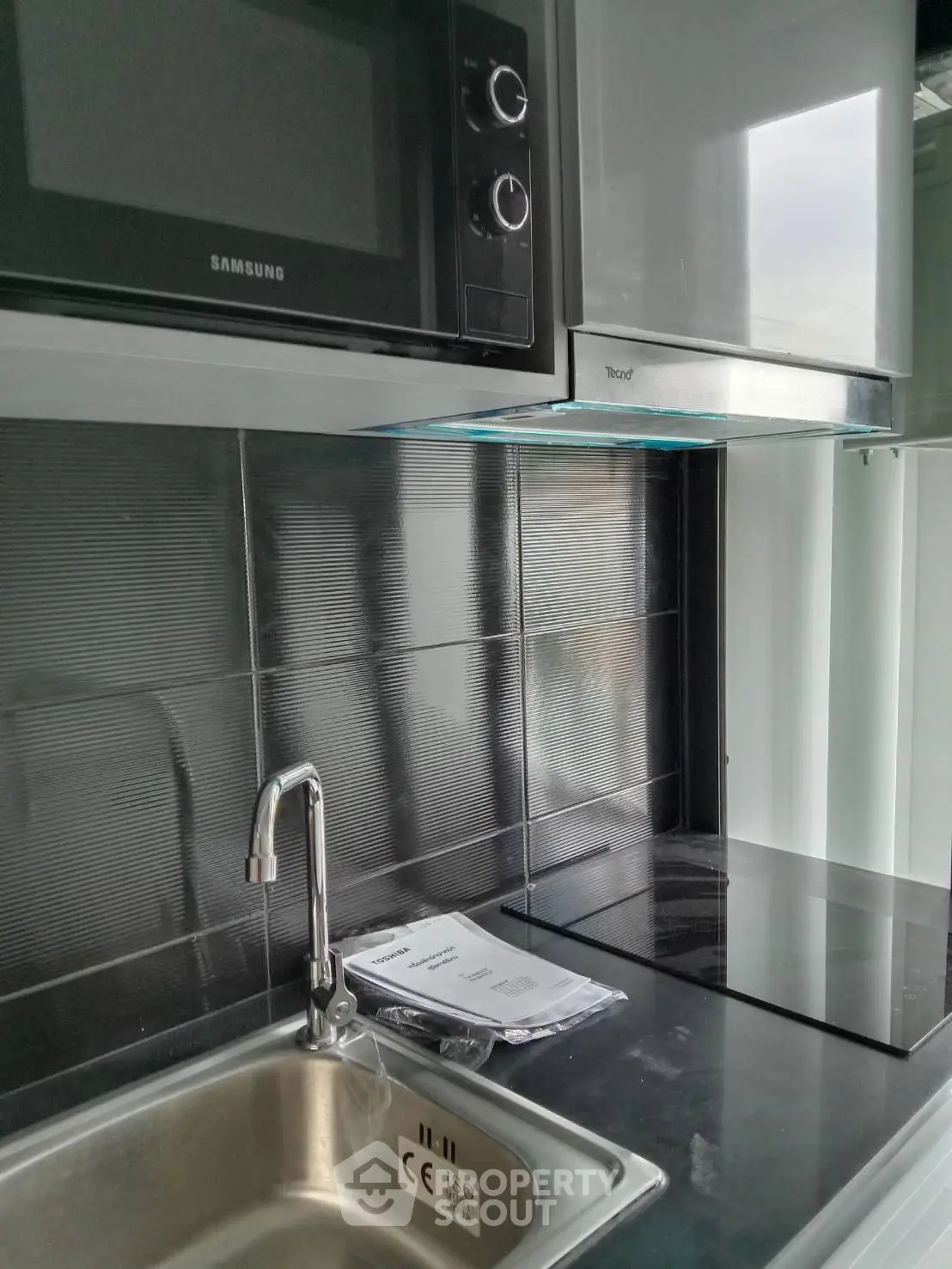 Modern kitchen with sleek stainless steel appliances and sink