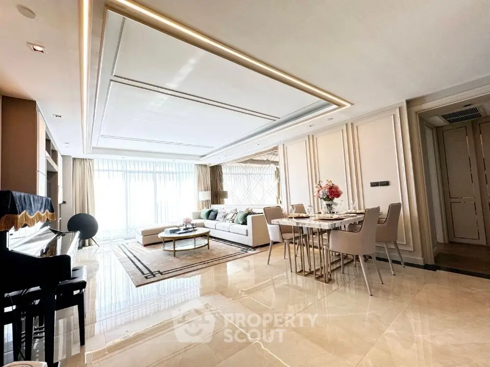 Luxurious open-plan living and dining area with elegant decor and abundant natural light.