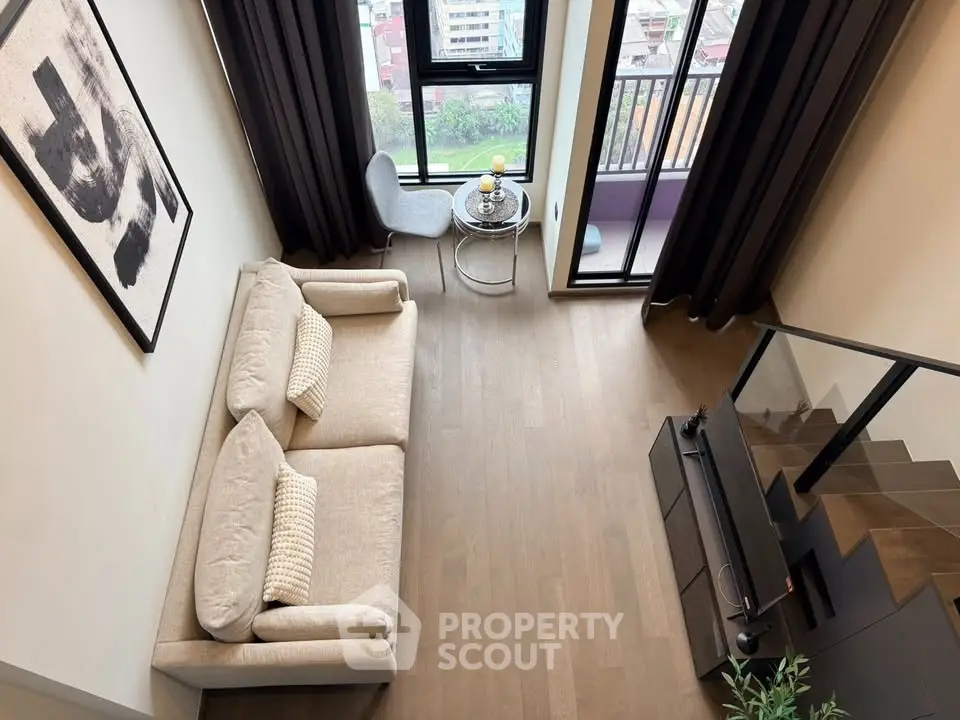 Modern loft living room with high ceiling and balcony view