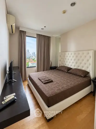 Luxurious bedroom with city view, featuring elegant decor and modern amenities for ultimate comfort.