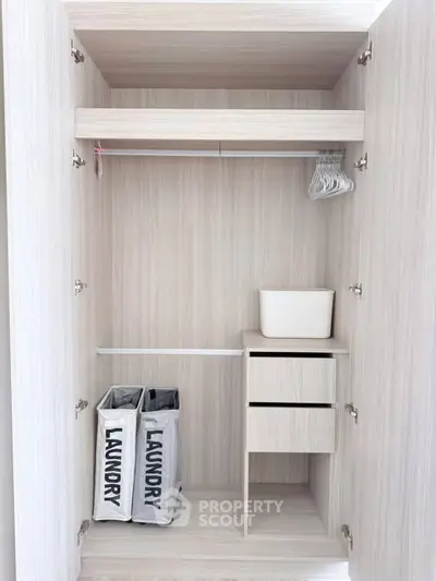 Spacious modern wardrobe with laundry baskets and storage drawers
