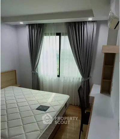 Cozy bedroom with modern decor and ample natural light