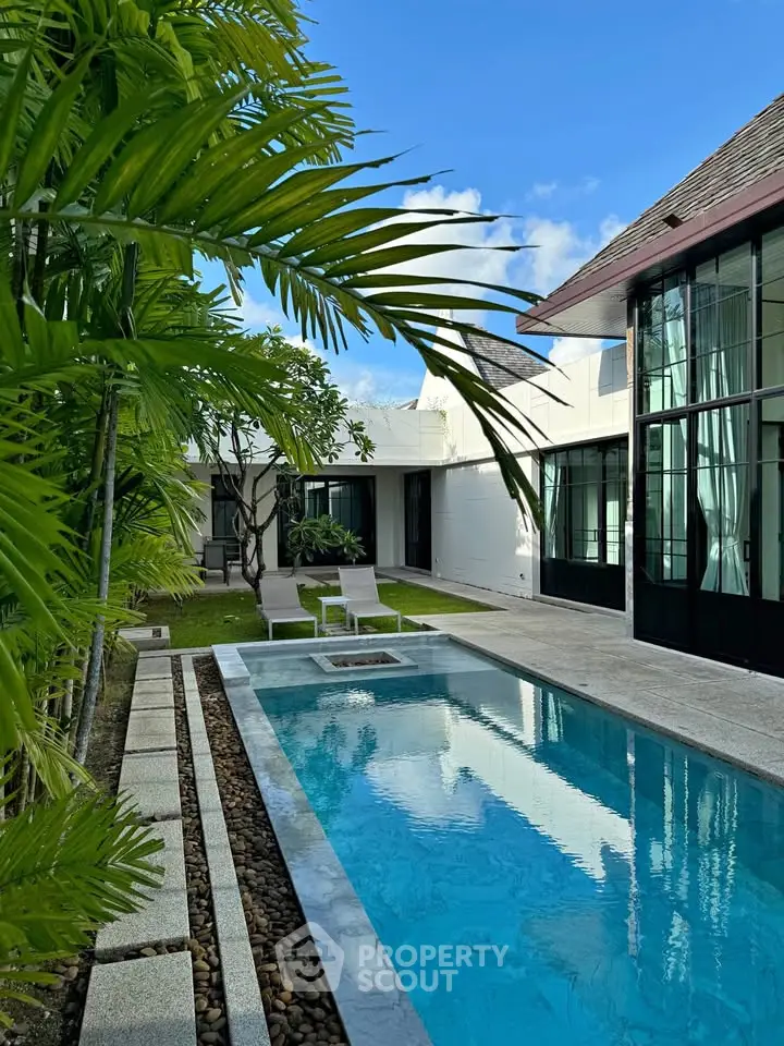 Luxurious modern villa with private pool and lush garden, perfect for relaxation and entertaining.