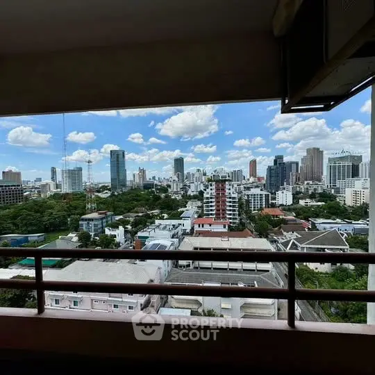 Stunning cityscape view from a high-rise balcony overlooking urban skyline.