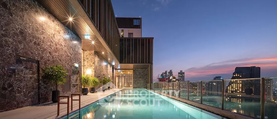 Luxurious rooftop pool with stunning city skyline view at sunset.