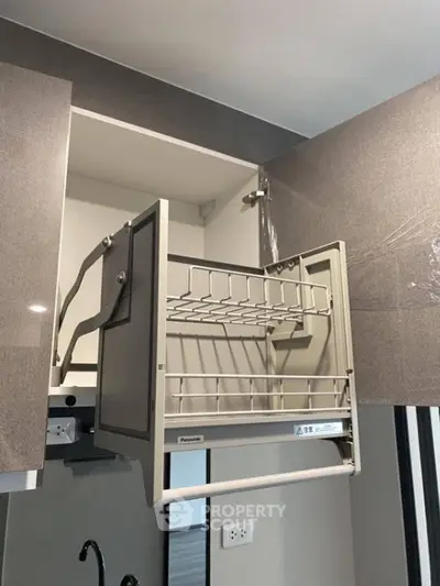 Modern kitchen cabinet with pull-down dish rack and sleek design